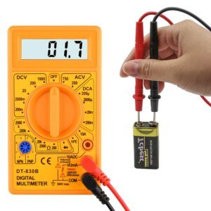 A digital multimeter displaying a reading of 01.7 is shown, with a hand holding probes connected to a battery. The multimeter is orange with a rotary dial and various measurement settings.