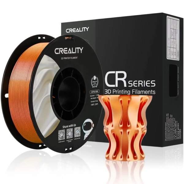 A spool of orange 3D printing filament next to a decorative orange 3D printed vase, with a black box labelled "CREALITY CR SERIES 3D Printing Filaments" in the background.