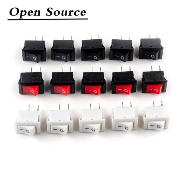 A collection of electrical switches in various colours: black and white rectangular switches with two pins, and red switches integrated into black ones, arranged in two rows. The top row features mostly black switches with a mix of red, while the bottom row consists of white switches.