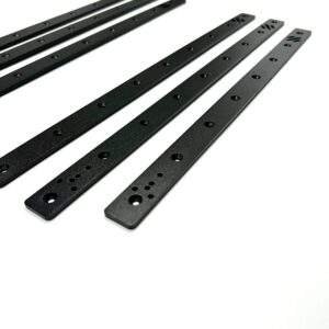A set of five black metal strips lined up parallel, each featuring multiple holes for fastening, with varying designs at one end.