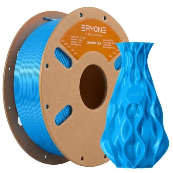 A spool of blue 3D printer filament next to a blue, intricately designed 3D-printed vase. The spool is made of cardboard and features an orange label with specifications for the filament.